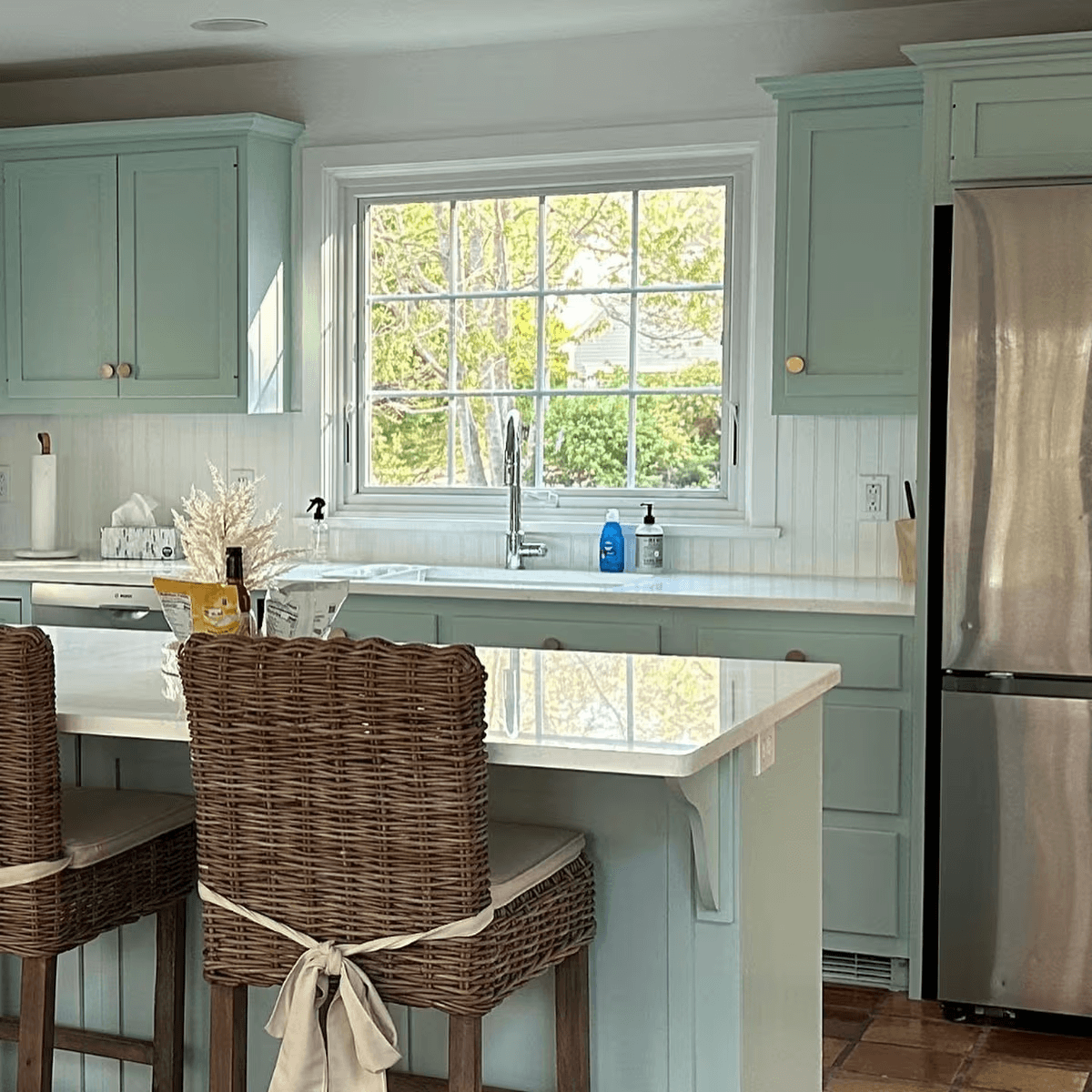 Awning window above a kitchen sink in a coastal-style home