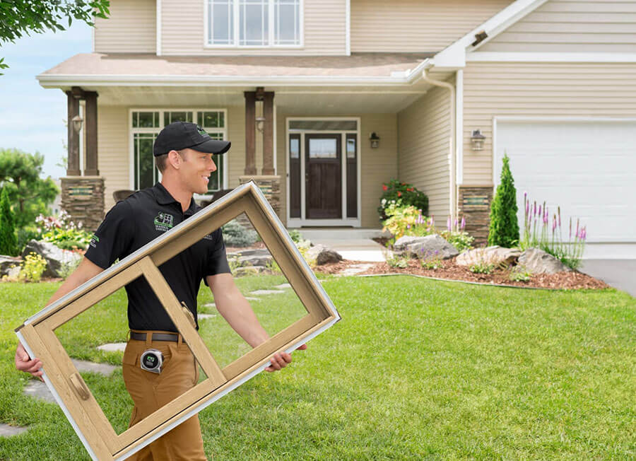 Installer carrying a new window to the home